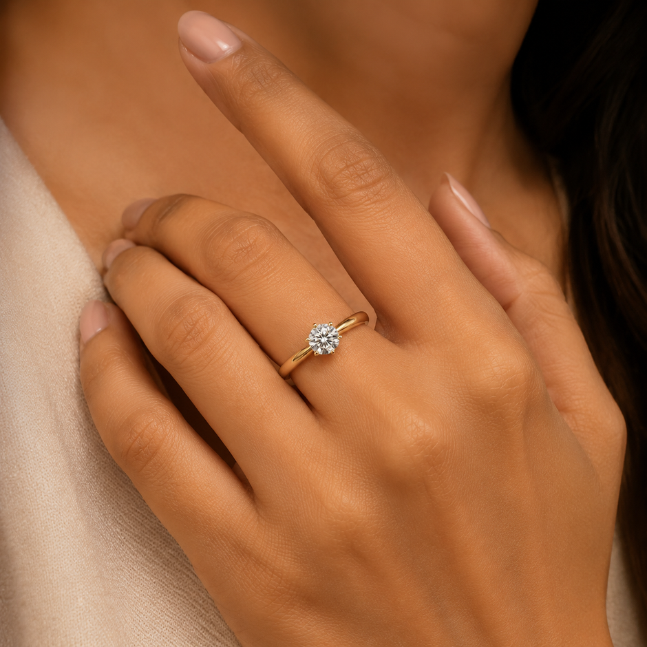 Model wearing Celestia Round Solitaire lab-grown diamond ring in 18K yellow gold