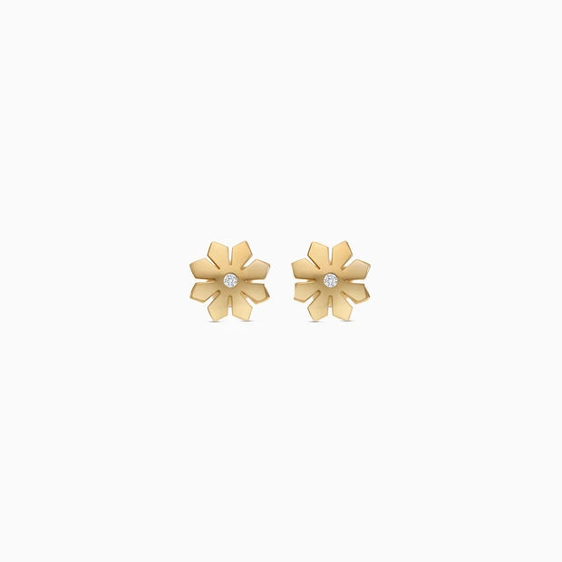 A pair of gold flower stud earrings with a small clear gemstone in the center of each flower, displayed on a clean white background.