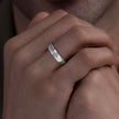Silver Men Diamond Ring on a person's finger with a blurred background
