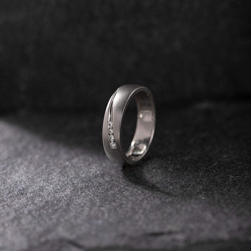 Silver Men Diamond  ring with small diamonds on a dark textured surface