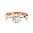 Rose gold ring with a diamond flower design on a white background