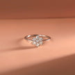 White Gold Engagement Diamond Ring with a diamond flower setting on a peach-colored fabric background