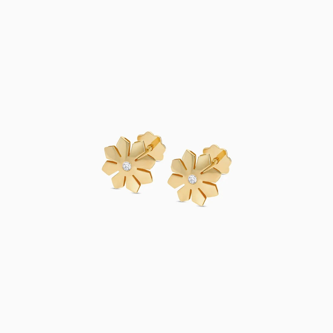 A pair of gold flower stud earrings with a small clear crystal in the center of each flower, shown on a plain white background.