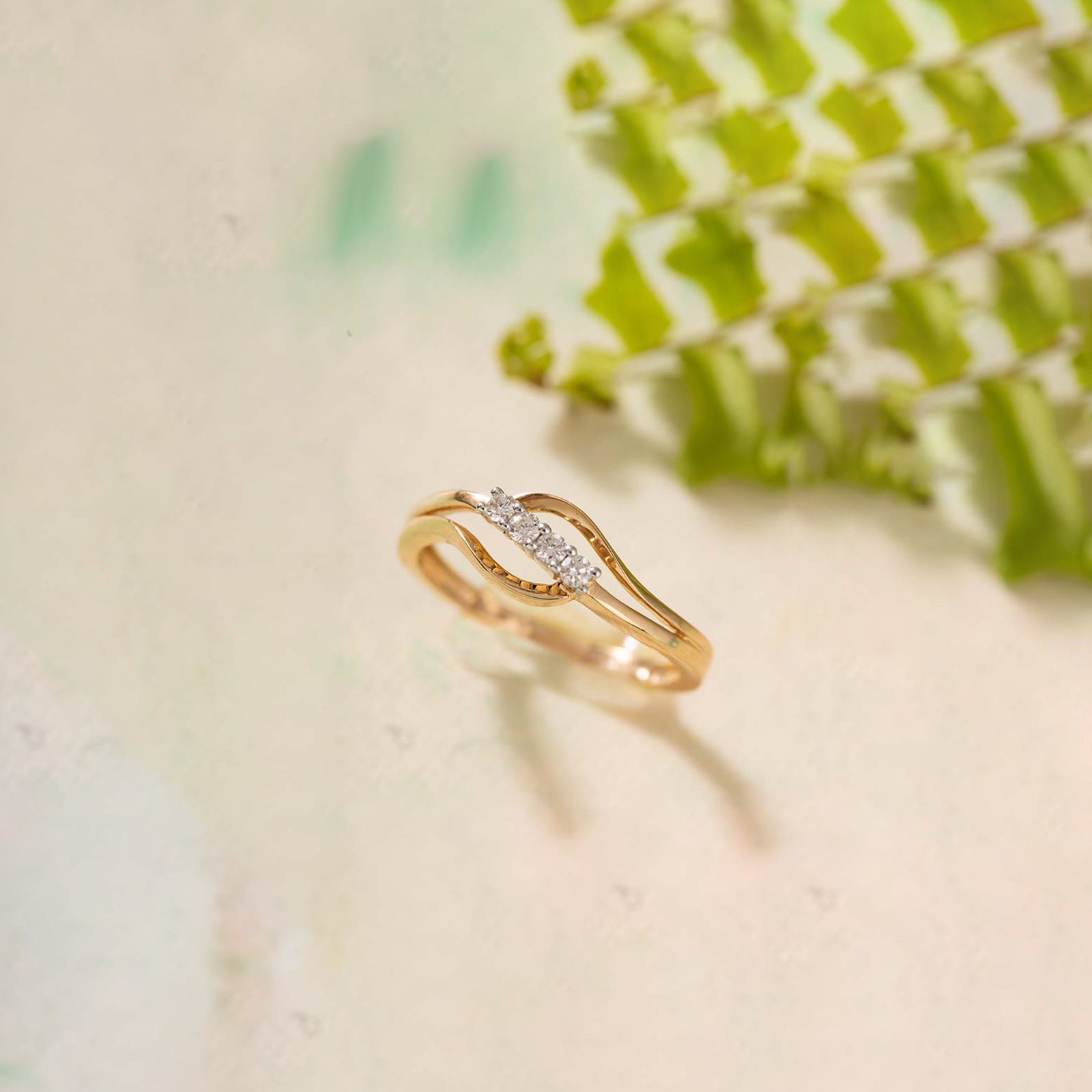 Gold ring with diamonds on a light background