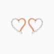 A pair of rose gold heart-shaped stud earrings with clear pavé-set diamonds along the outer edges, shown on a clean white background.