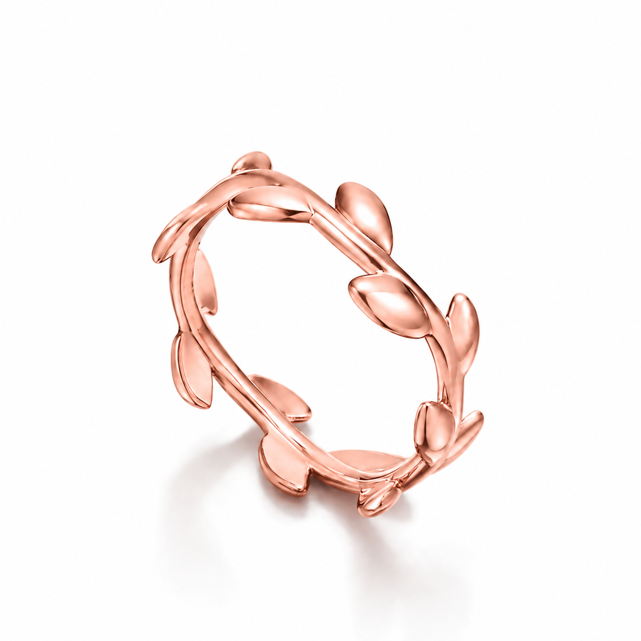 A rose Silver ring designed to look like a leafy vine or branch, photographed on a clean white background with a soft shadow