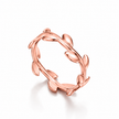 A rose Silver ring designed to look like a leafy vine or branch, photographed on a clean white background with a soft shadow