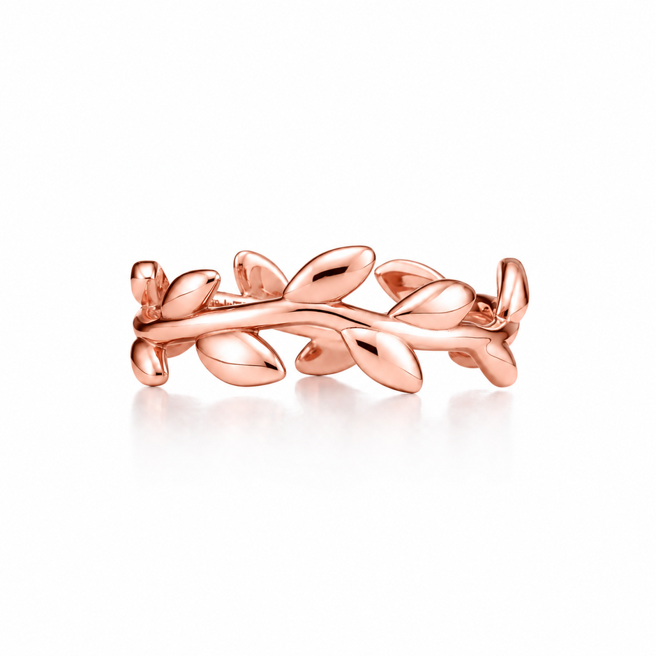 A polished rose Silver ring designed as a leafy vine branch, shown on a clean white background with a soft reflection.