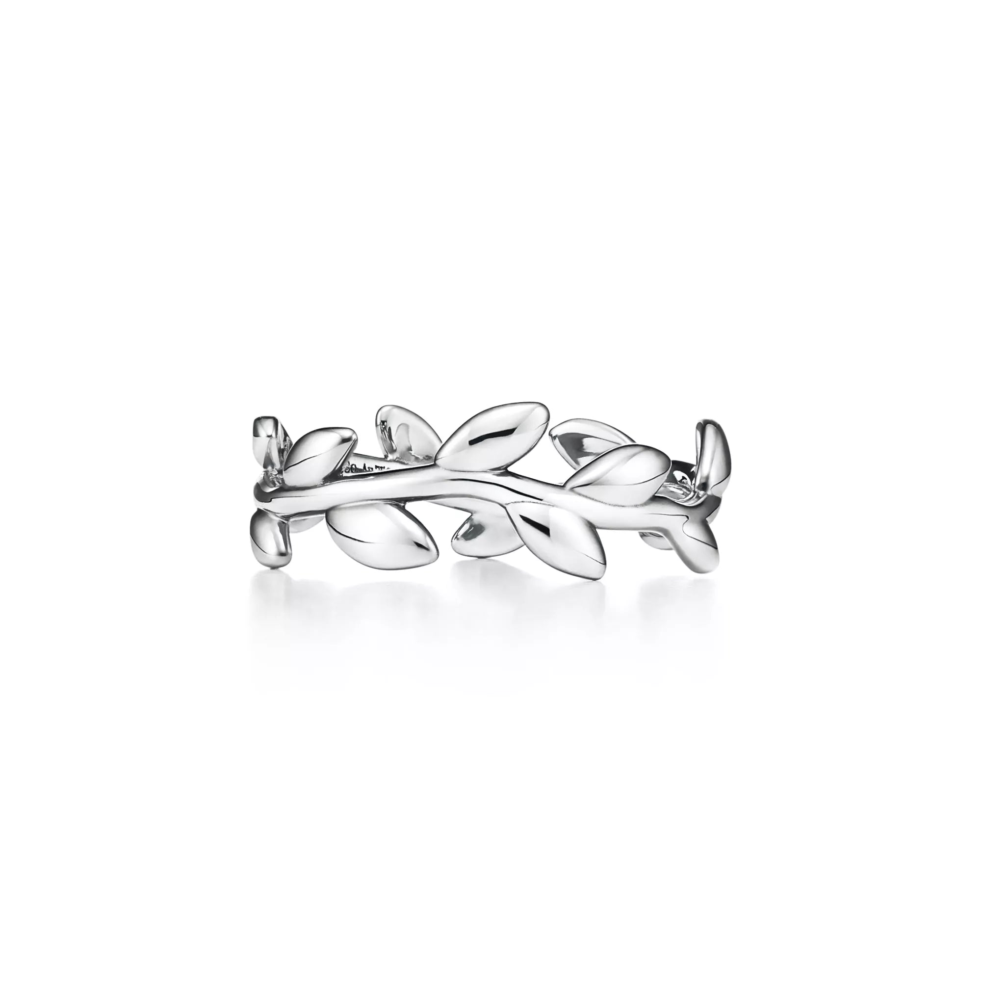 A silver ring designed as a leafy branch wreath, shown on a clean white background with a soft reflection underneath.