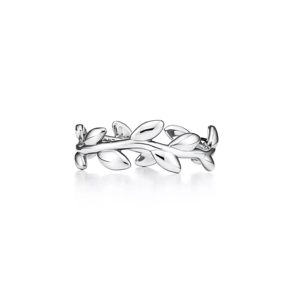 A silver ring designed as a leafy branch wreath, shown on a clean white background with a soft reflection underneath.