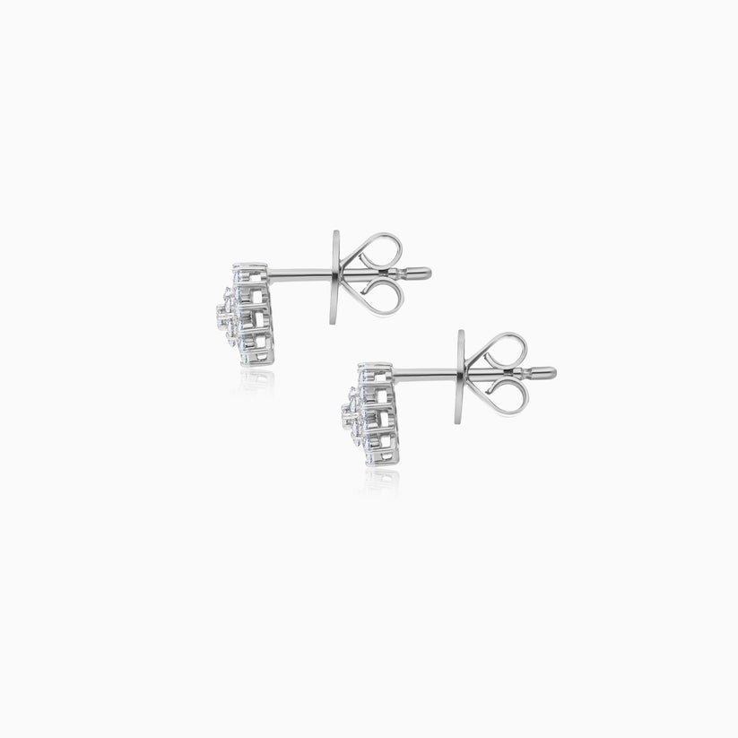 A pair of white stud earrings with square-cut clear gemstones, displayed on a clean white background with subtle reflections.