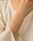Meher Tennis Line Women Silver Bracelet worn on a woman's wrist, white 925 sterling silver lifestyle view