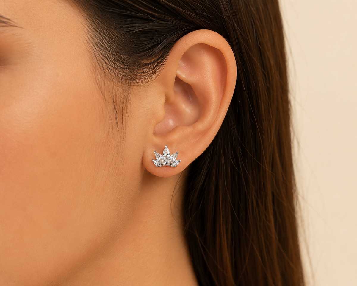 Noor Crown Zircon Silver Stud Earrings worn on a woman's ear, white 925 sterling silver lifestyle view