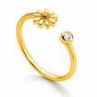 A gold platted Women Silver  open ring ring featuring a small daisy flower on one end and a round clear gemstone on the other, shown on a white background.